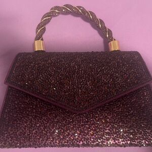 Sparkly purple with gold hardware handbag with chain.